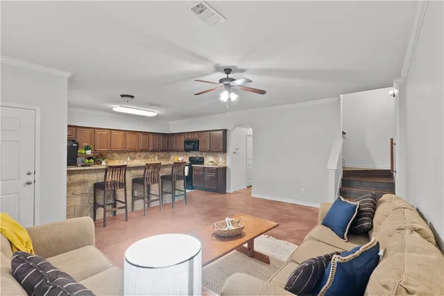 a living room with furniture and kitchen view