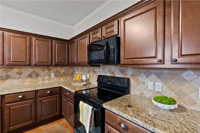 a kitchen with granite countertop wood cabinets and a stove top oven
