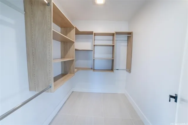 a view of walk in closet with empty racks