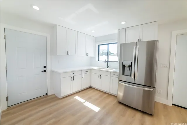 a kitchen with stainless steel appliances a refrigerator sink and cabinets