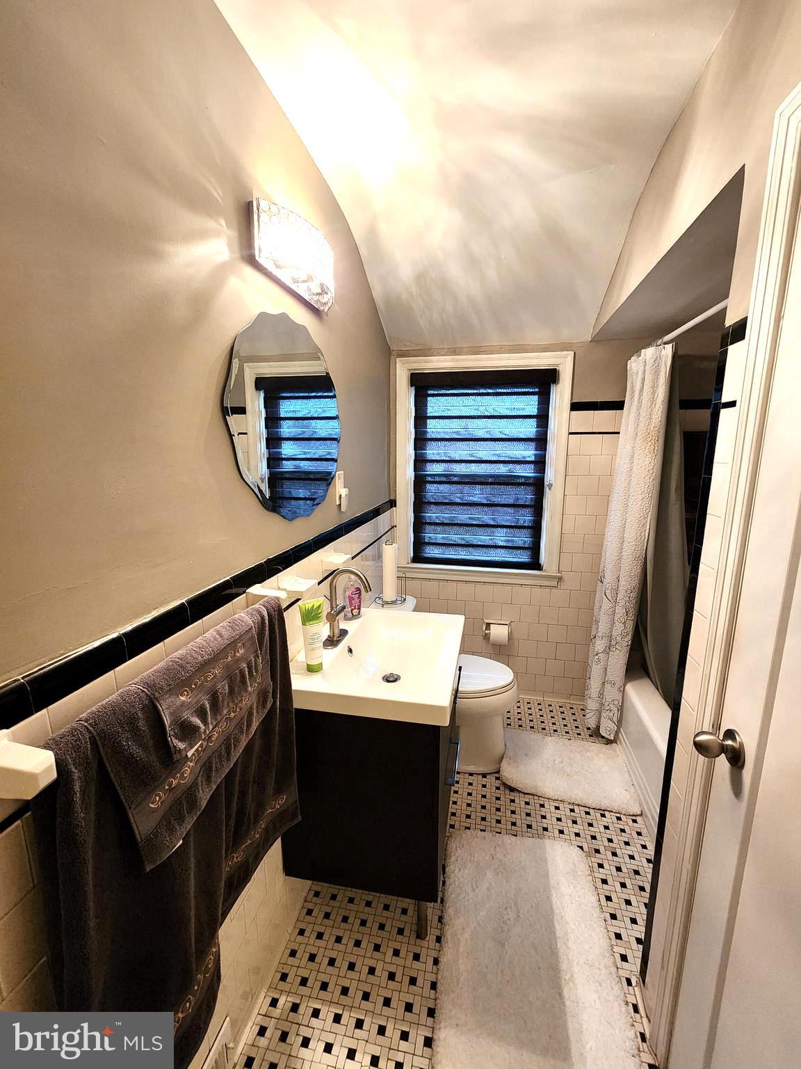 1229 Winston Avenue Baltimore, MD 21239 - Photo 13 of 19 a bathroom with a sink toilet and a mirror