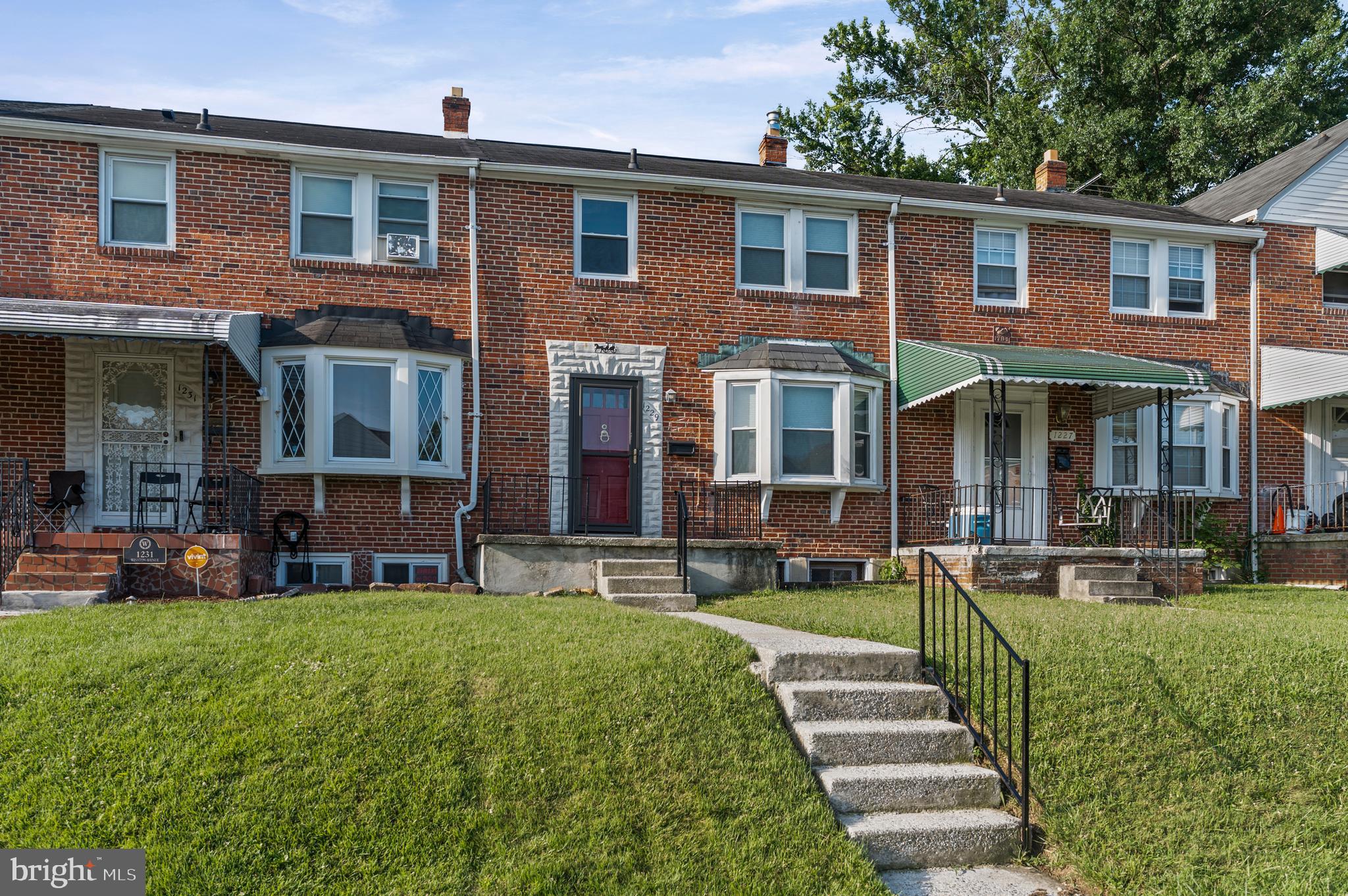 1229 Winston Avenue Baltimore, MD 21239 - Photo 17 of 19 a front view of a house with a yard