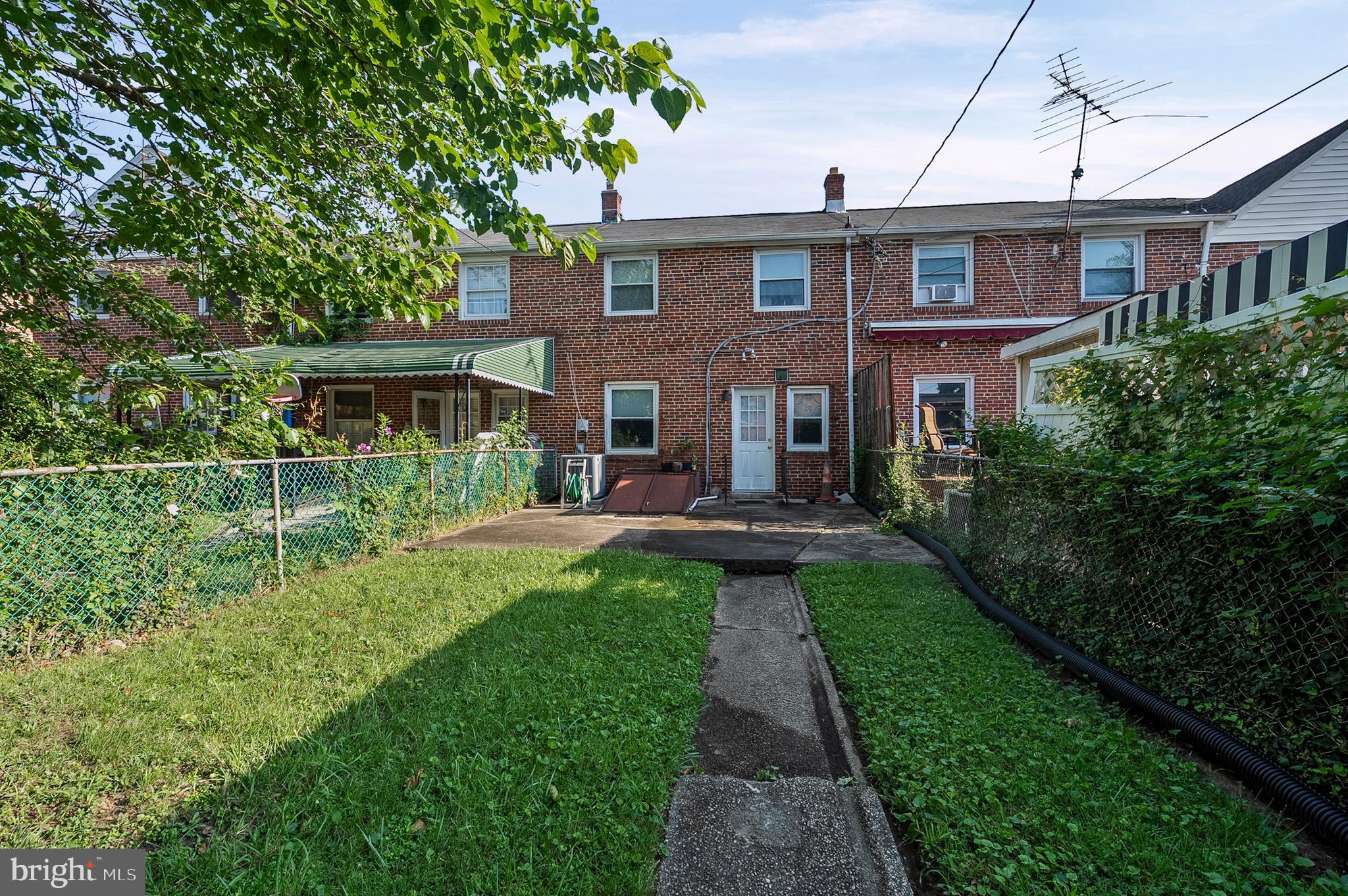 1229 Winston Avenue Baltimore, MD 21239 - Photo 19 of 19 a front view of a house with yard and green space