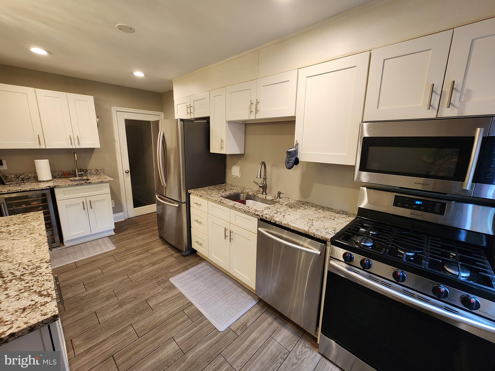 1229 Winston Avenue Baltimore, MD 21239 - Photo 3 of 19 a kitchen with stainless steel appliances granite countertop a stove refrigerator sink and microwave