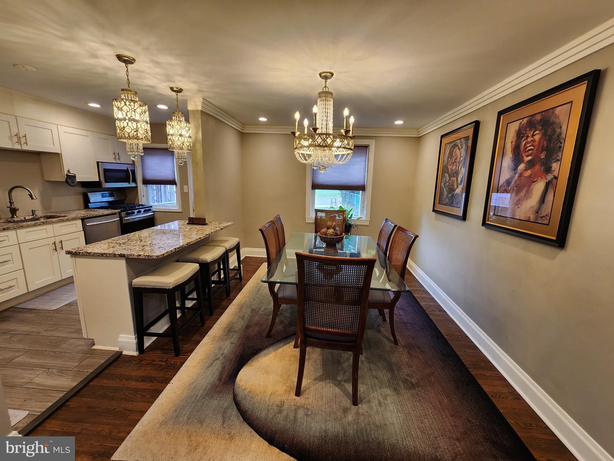 1229 Winston Avenue Baltimore, MD 21239 - Photo 4 of 19 a kitchen with sink stove dining table and chairs