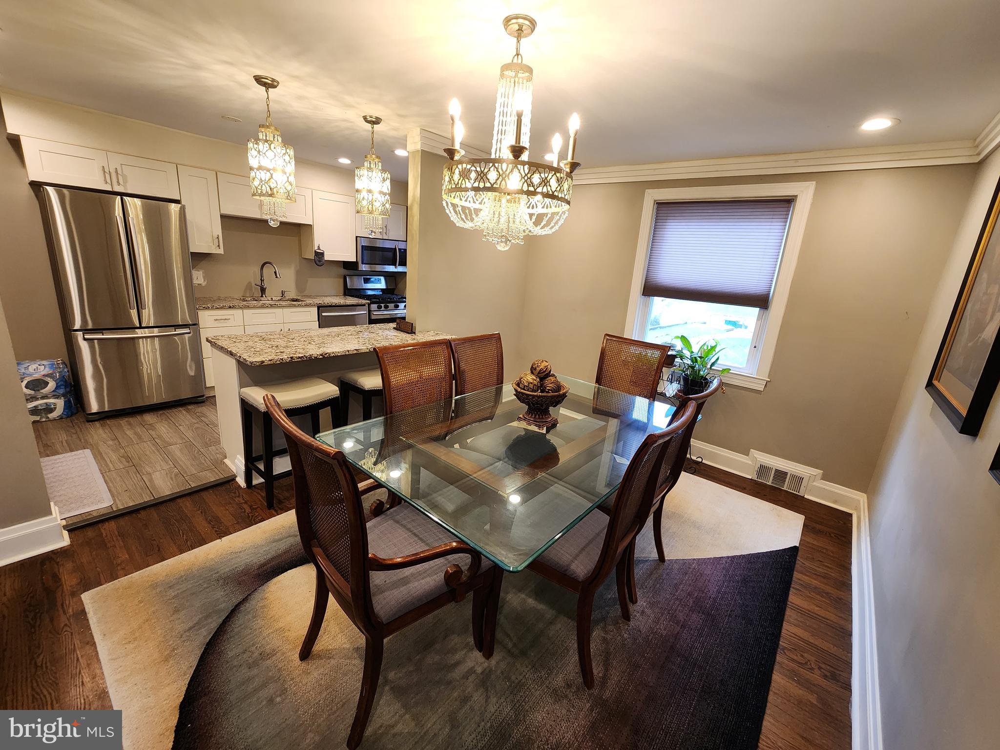 1229 Winston Avenue Baltimore, MD 21239 - Photo 5 of 19 a view of a dining room with furniture and a chandelier
