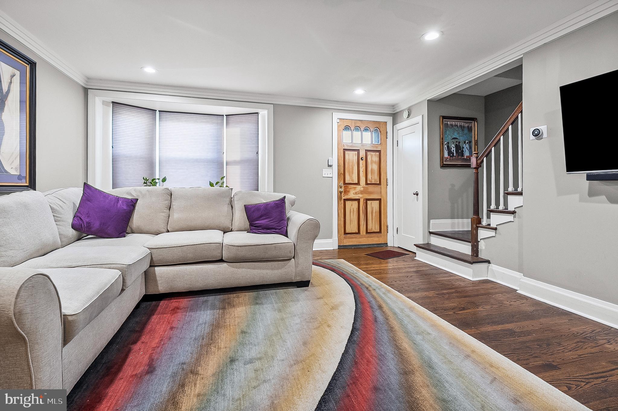 1229 Winston Avenue Baltimore, MD 21239 - Photo 6 of 19 a living room with furniture and a flat screen tv