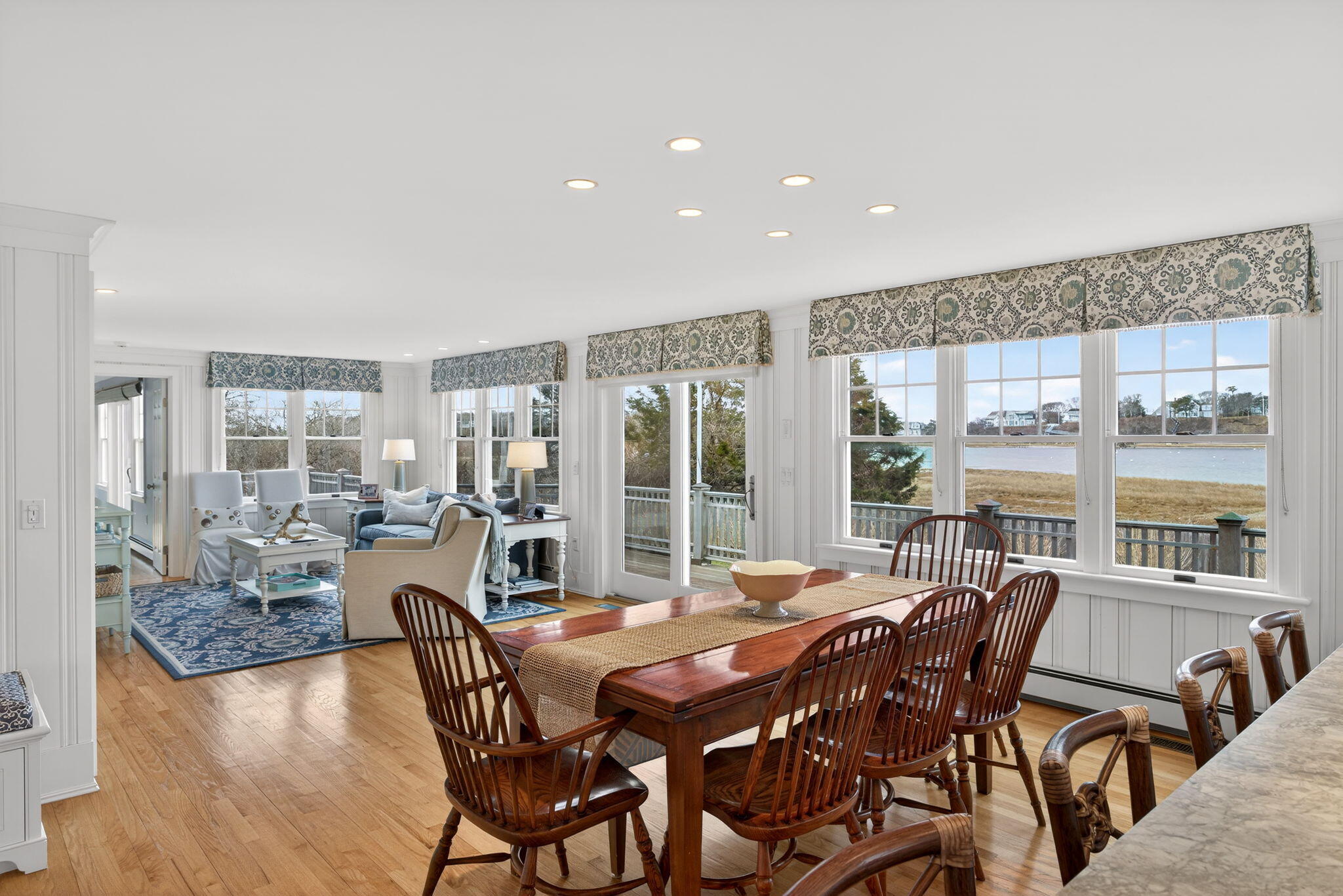 346 Morris Island Road Chatham, MA 02633 - Photo 14 of 33 a dining room with furniture a chandelier and wooden floor