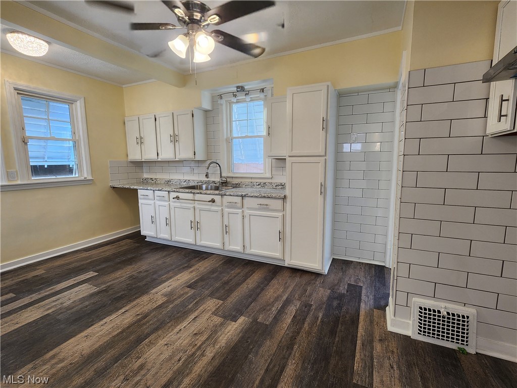 17814 Crestland Road Cleveland, OH 44119 - Photo 8 of 49 Kitchen featuring plenty of natural light, dark wood-type flooring, and white cabinets