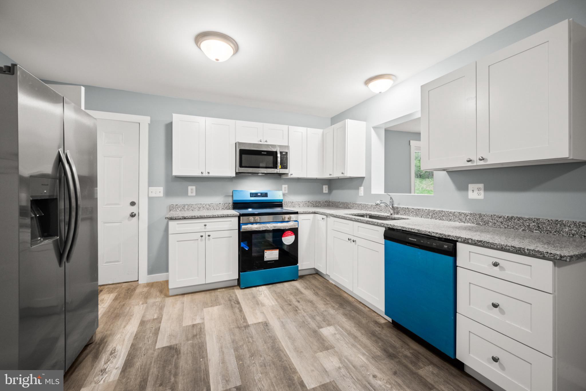 4714 Ladiesburg Road Union Bridge, MD 21791 - Photo 11 of 34 a kitchen with a refrigerator stove and sink