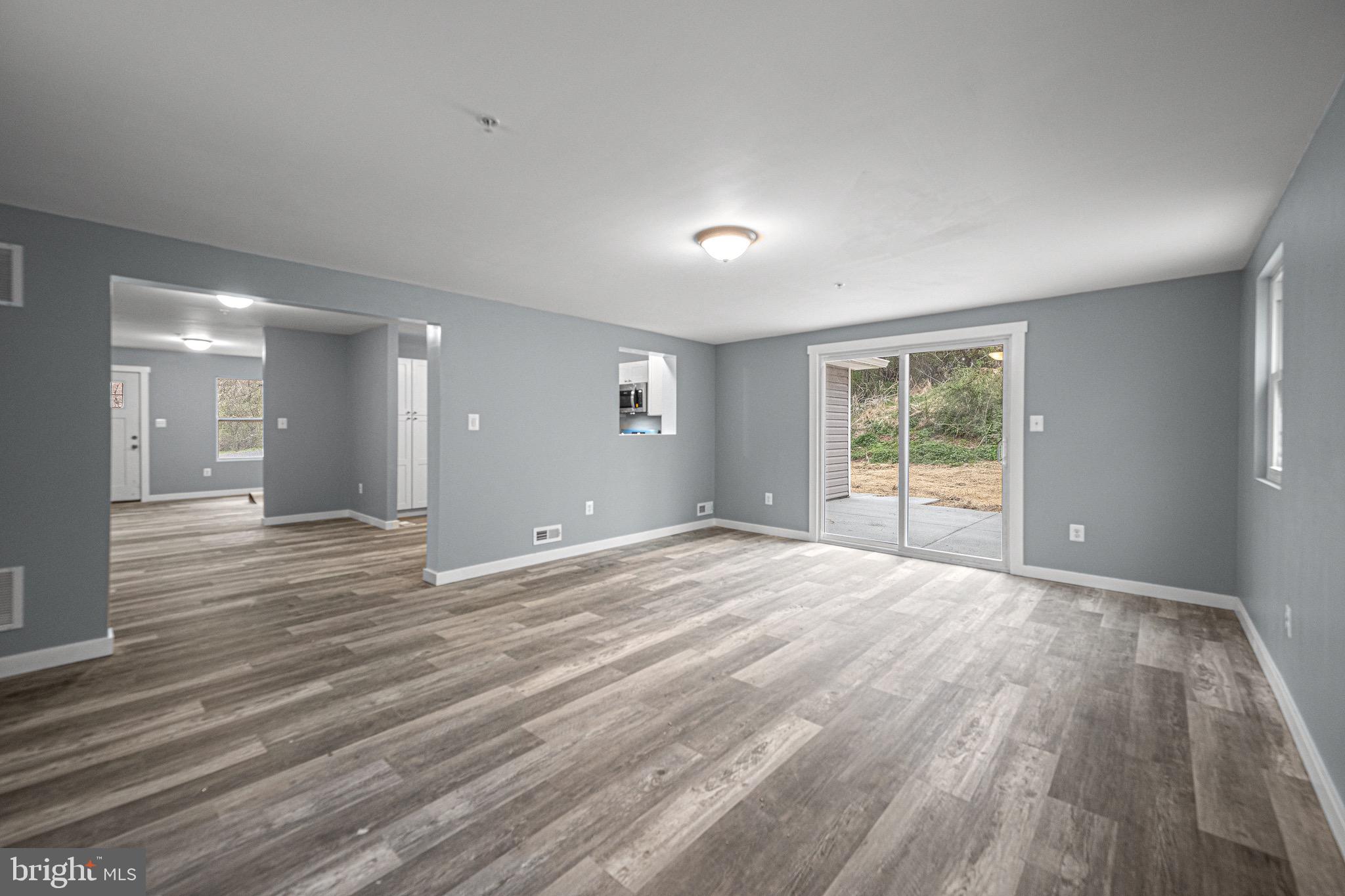4714 Ladiesburg Road Union Bridge, MD 21791 - Photo 15 of 34 a view of an empty room with wooden floor and a window