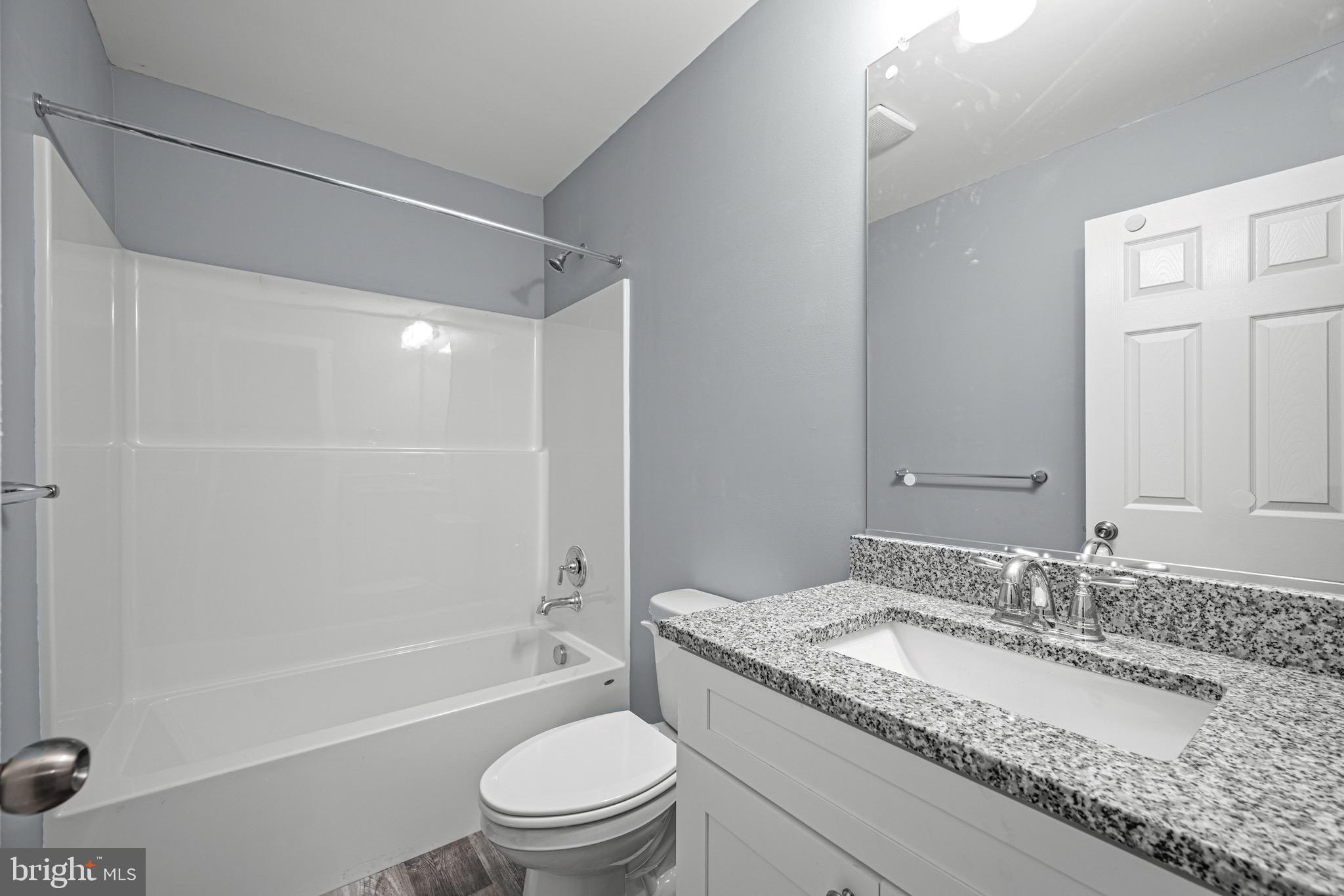 4714 Ladiesburg Road Union Bridge, MD 21791 - Photo 22 of 34 a bathroom with a granite countertop sink toilet mirror and shower