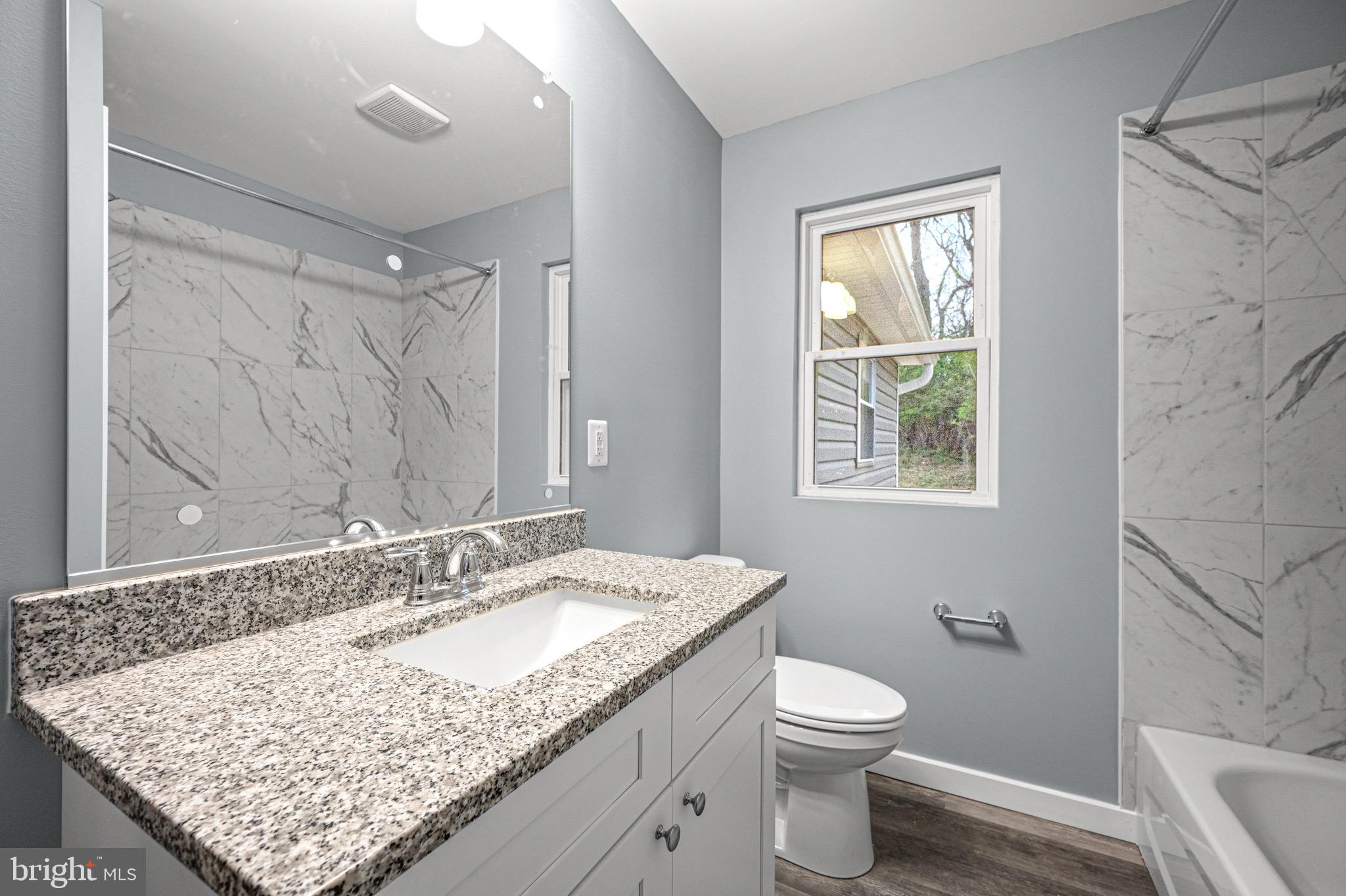 4714 Ladiesburg Road Union Bridge, MD 21791 - Photo 6 of 34 a bathroom with a granite countertop sink toilet and shower