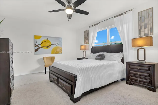 a bedroom with a bed a couch and a painting on the wall