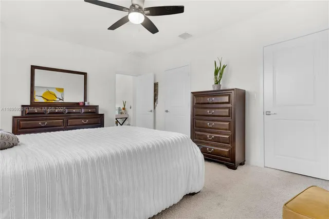 a bedroom with a bed and a dresser