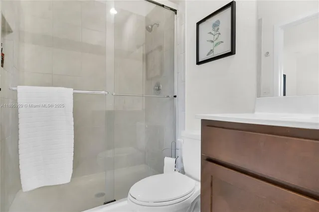 a white toilet sitting next to a bathroom sink