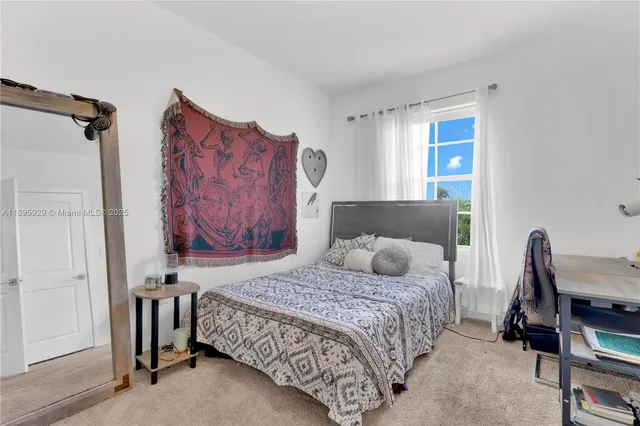 a bedroom with a bed and a table in it