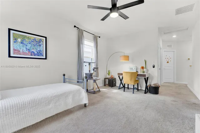 a bedroom with bed and a chandelier