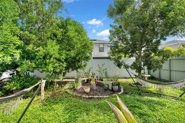 a view of a chair and tables in the backyard