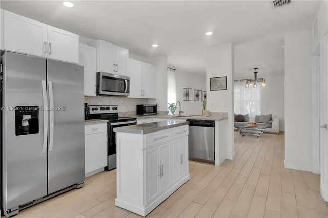 a kitchen with a sink stainless steel appliances and cabinets