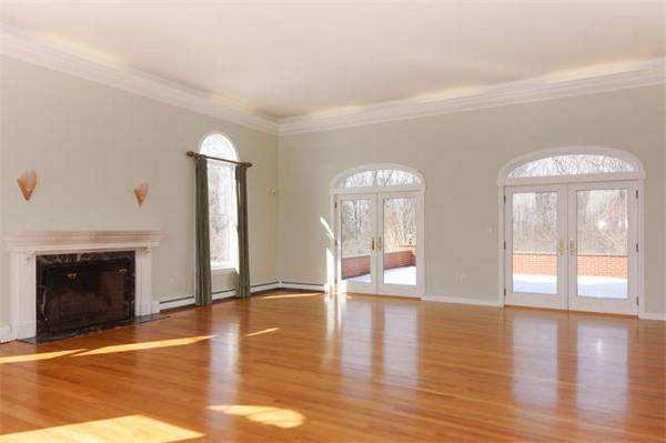 231 Old Littleton Road Harvard, MA 01451 - Photo 5 of 30 a view of an empty room with wooden floor and a fireplace