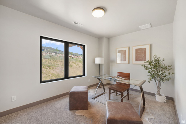 10646 North Reflection Ridge Hideout, UT 84036 - Photo 20 of 43 Room featuring a large black-framed window, neutral wall paint, gray carpeting, a single ceiling light fixture, and gray baseboards