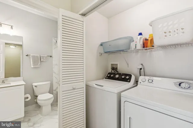 a bathroom with a toilet sink and shower