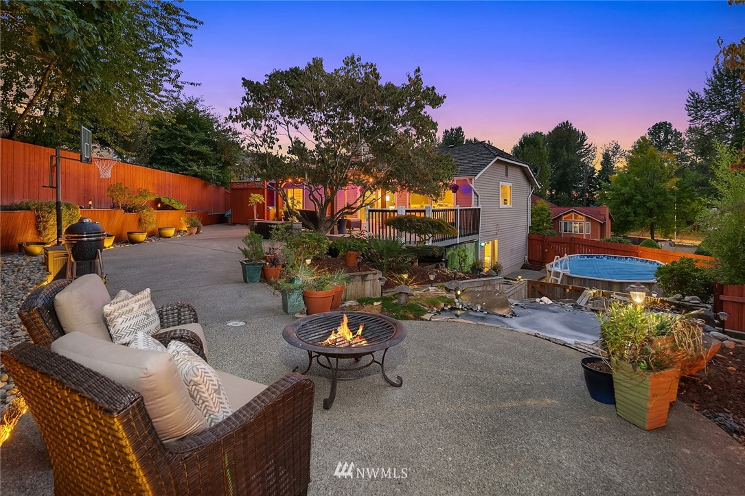 2526 Mill Avenue South Renton, WA 98055 - Photo 3 of 33 a roof deck with table and chairs potted plants and a large tree