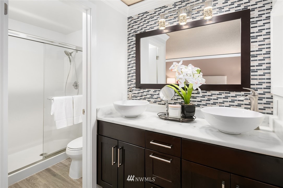 2526 Mill Avenue South Renton, WA 98055 - Photo 9 of 33 a bathroom with a granite countertop sink a toilet and a shower