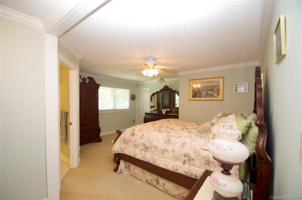 2005 Clontz Long Road Monroe, NC 28110 - Photo 12 of 24 a bedroom with a bed and a chandelier