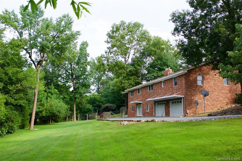 2005 Clontz Long Road Monroe, NC 28110 - Photo 21 of 24 a big white house with a big yard and large trees