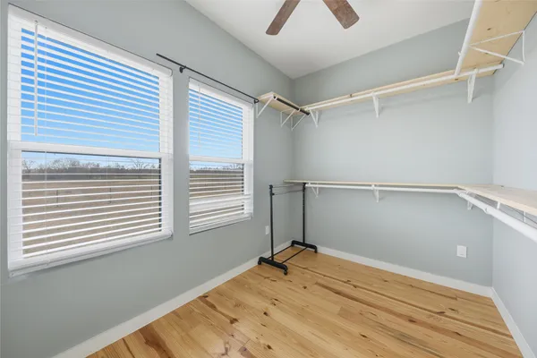 a view of a room with a wooden floor and a window