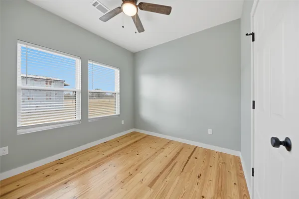 a view of a room with wooden floor and a window