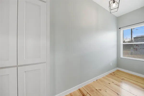 a view of a room with wooden floor and cabinet