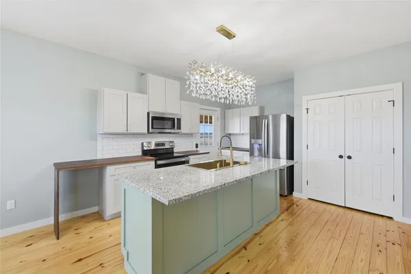 a kitchen with a sink stove and refrigerator