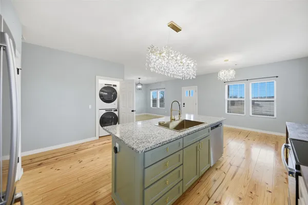 a kitchen with a sink and chandelier