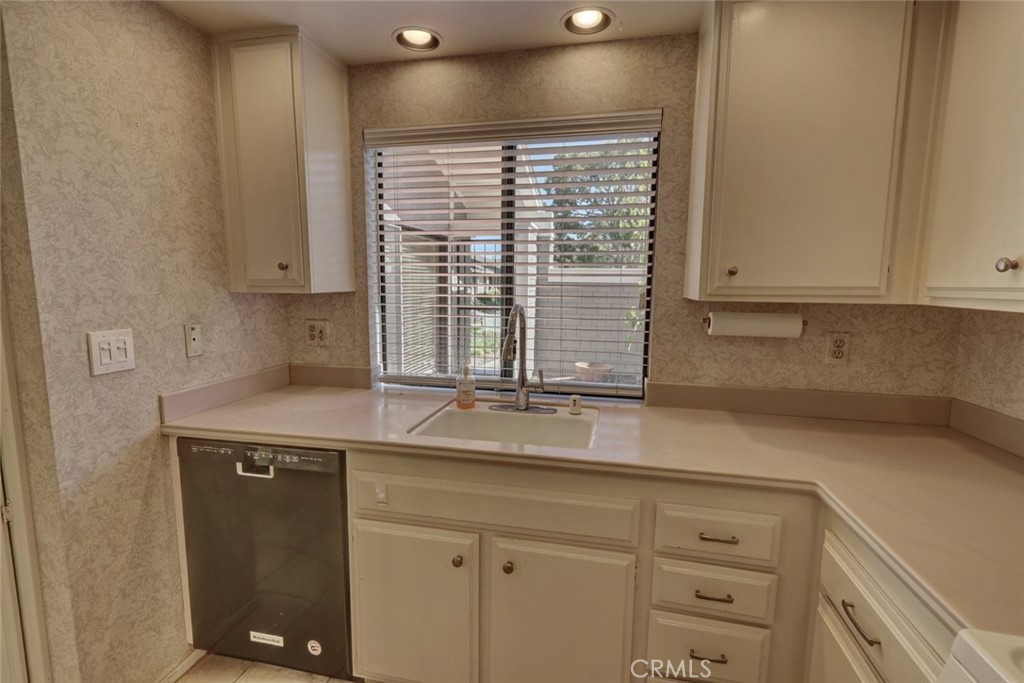 8566 Larkhall Circle, Unit 808A Huntington Beach, CA 92646 - Photo 15 of 46 a kitchen with a sink and cabinets
