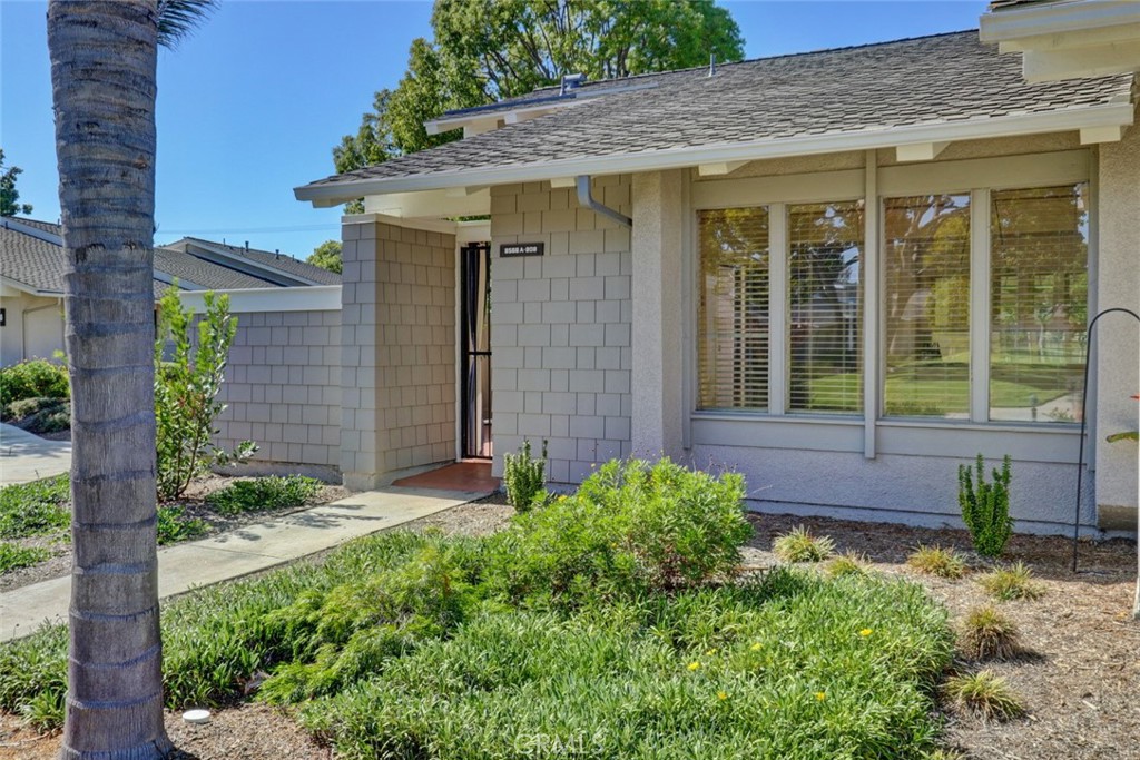 8566 Larkhall Circle, Unit 808A Huntington Beach, CA 92646 - Photo 2 of 46 a front view of a house with garden