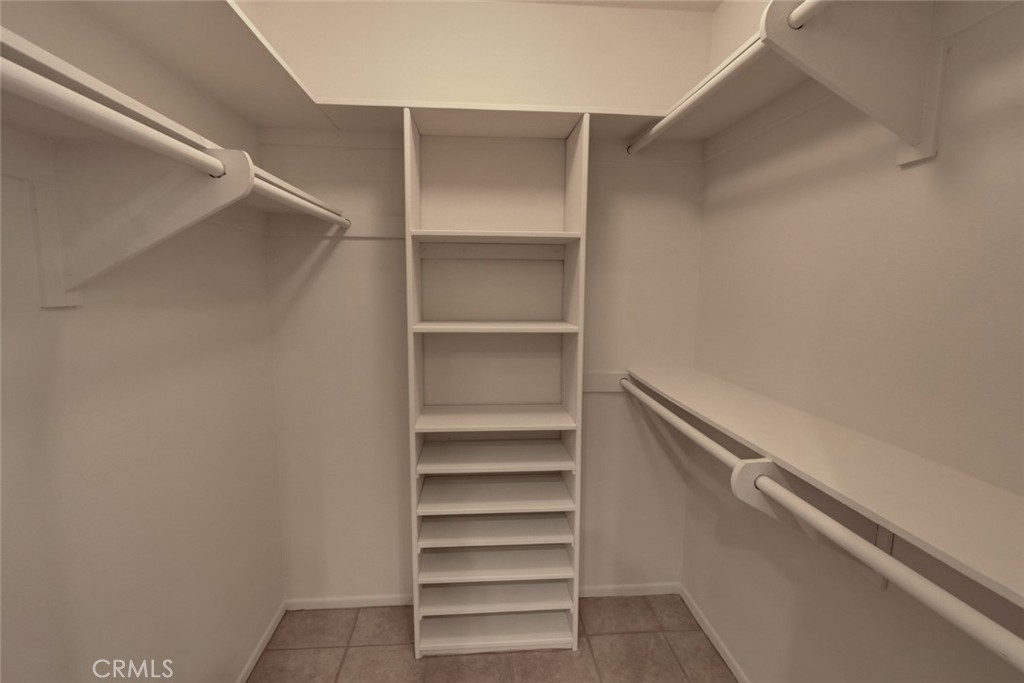 8566 Larkhall Circle, Unit 808A Huntington Beach, CA 92646 - Photo 21 of 46 a view of walk in closet with empty racks