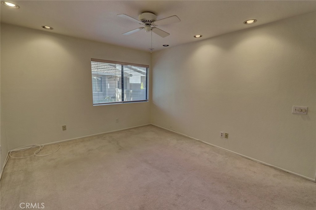 8566 Larkhall Circle, Unit 808A Huntington Beach, CA 92646 - Photo 24 of 46 an empty room with a window and a fan