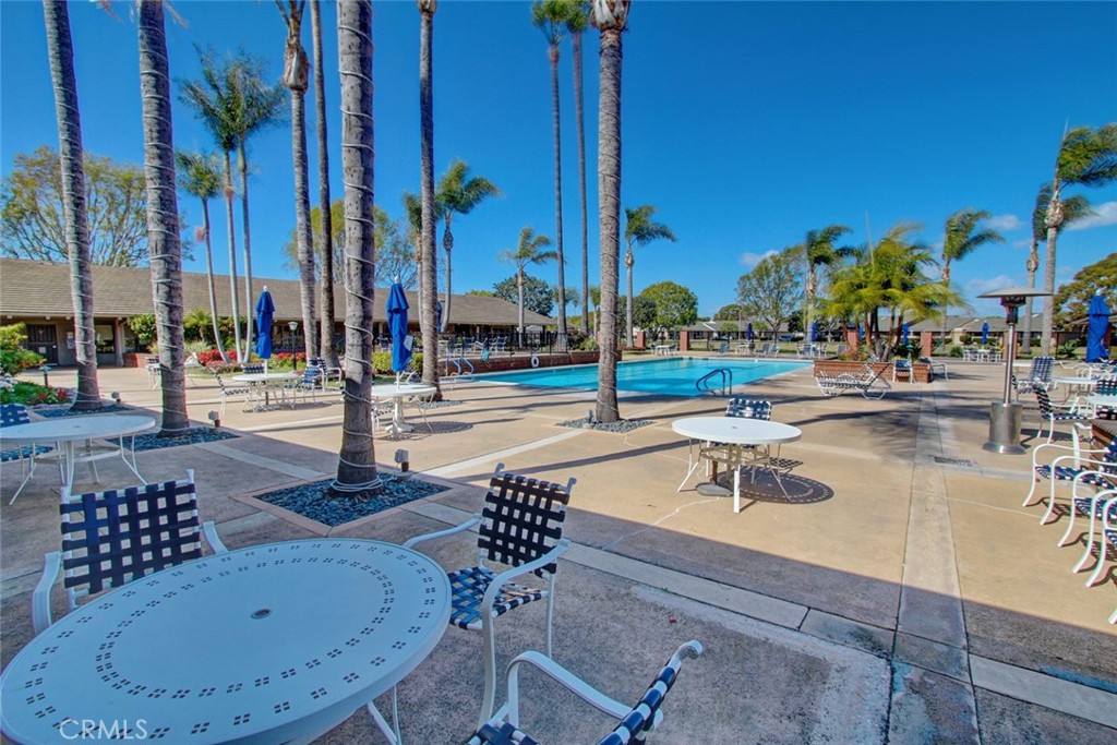 8566 Larkhall Circle, Unit 808A Huntington Beach, CA 92646 - Photo 34 of 46 a view of a swimming pool with a lawn chairs