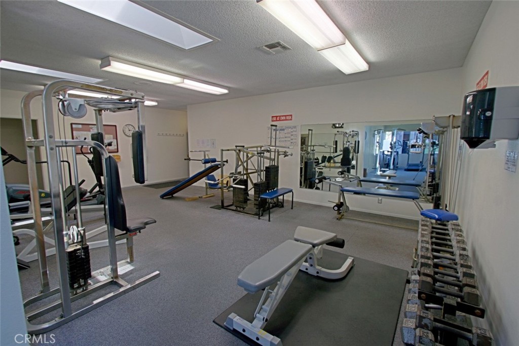 8566 Larkhall Circle, Unit 808A Huntington Beach, CA 92646 - Photo 40 of 46 a room with gym equipment and equipment