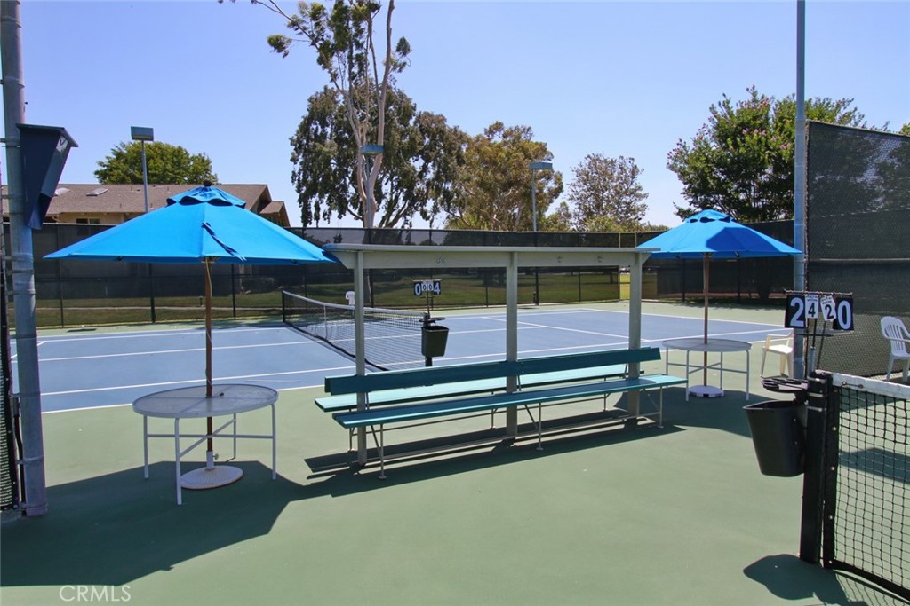 8566 Larkhall Circle, Unit 808A Huntington Beach, CA 92646 - Photo 43 of 46 a backyard of a house with table and chairs