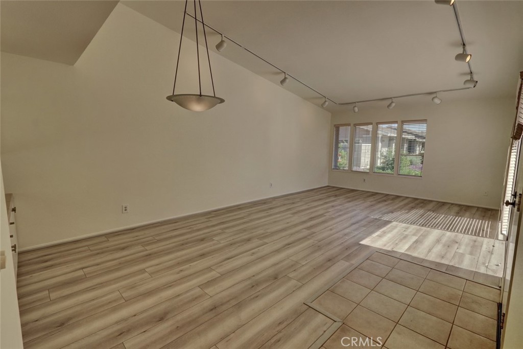 8566 Larkhall Circle, Unit 808A Huntington Beach, CA 92646 - Photo 10 of 46 an empty room with windows