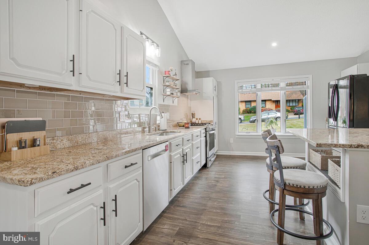 437 Kingwood Road Linthicum Heights, MD 21090 - Photo 11 of 38 a large kitchen with stainless steel appliances kitchen island granite countertop a sink and cabinets