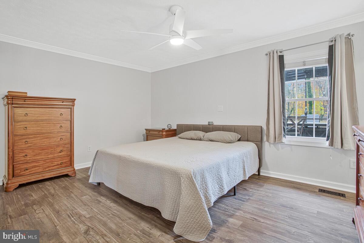 437 Kingwood Road Linthicum Heights, MD 21090 - Photo 16 of 38 a bedroom with a bed a dresser and a window