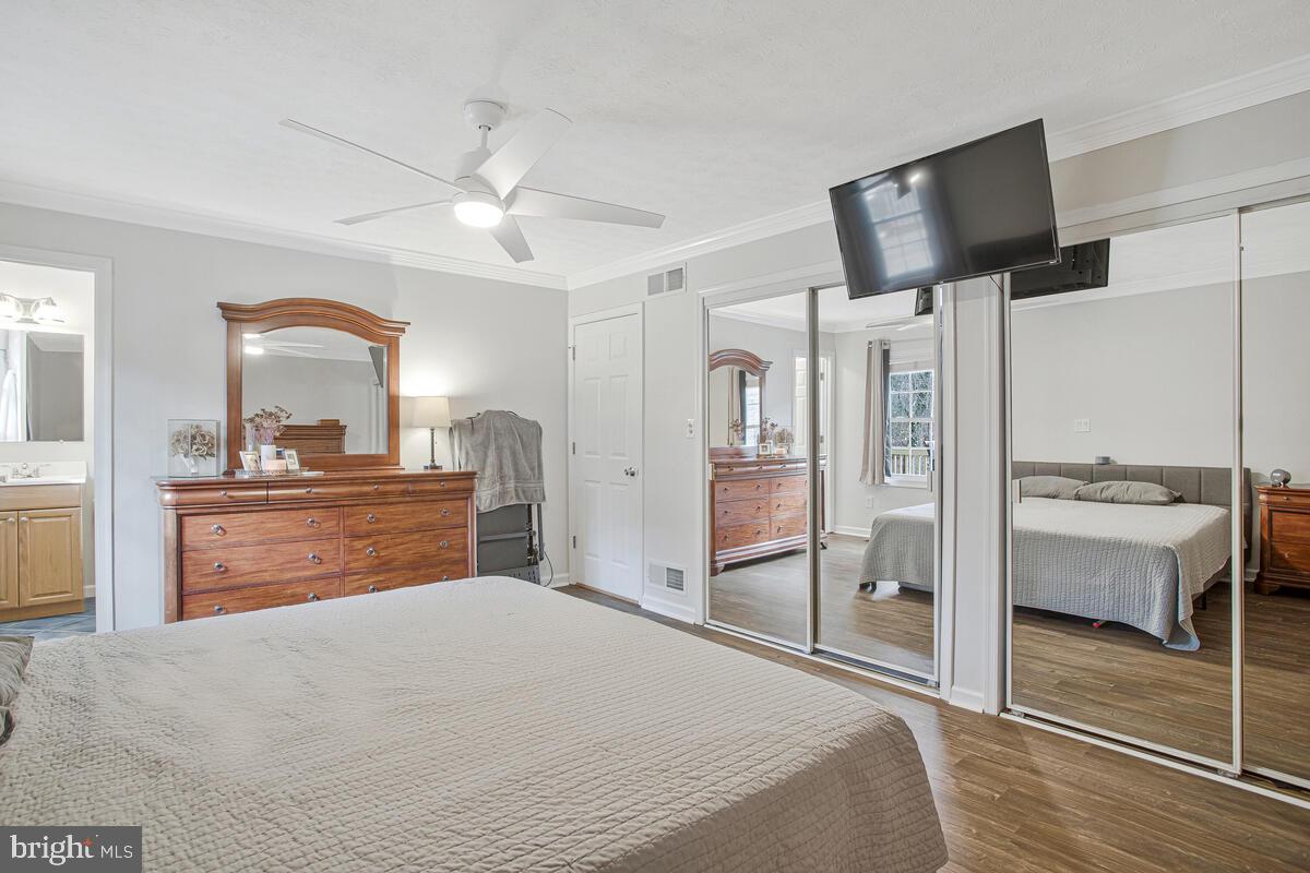 437 Kingwood Road Linthicum Heights, MD 21090 - Photo 18 of 38 a bedroom with a bed and a flat screen tv