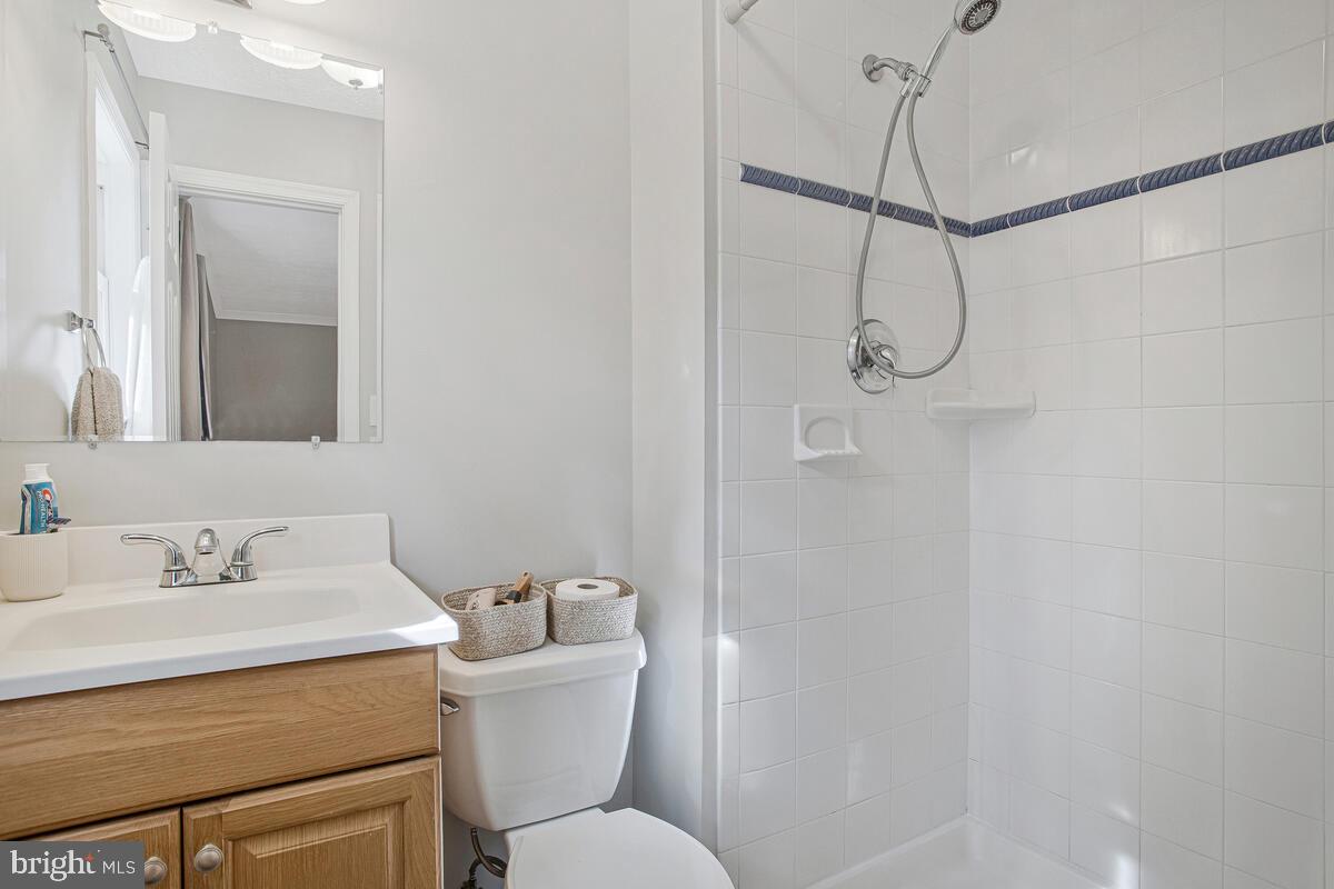 437 Kingwood Road Linthicum Heights, MD 21090 - Photo 19 of 38 a bathroom with a toilet sink shower and mirror