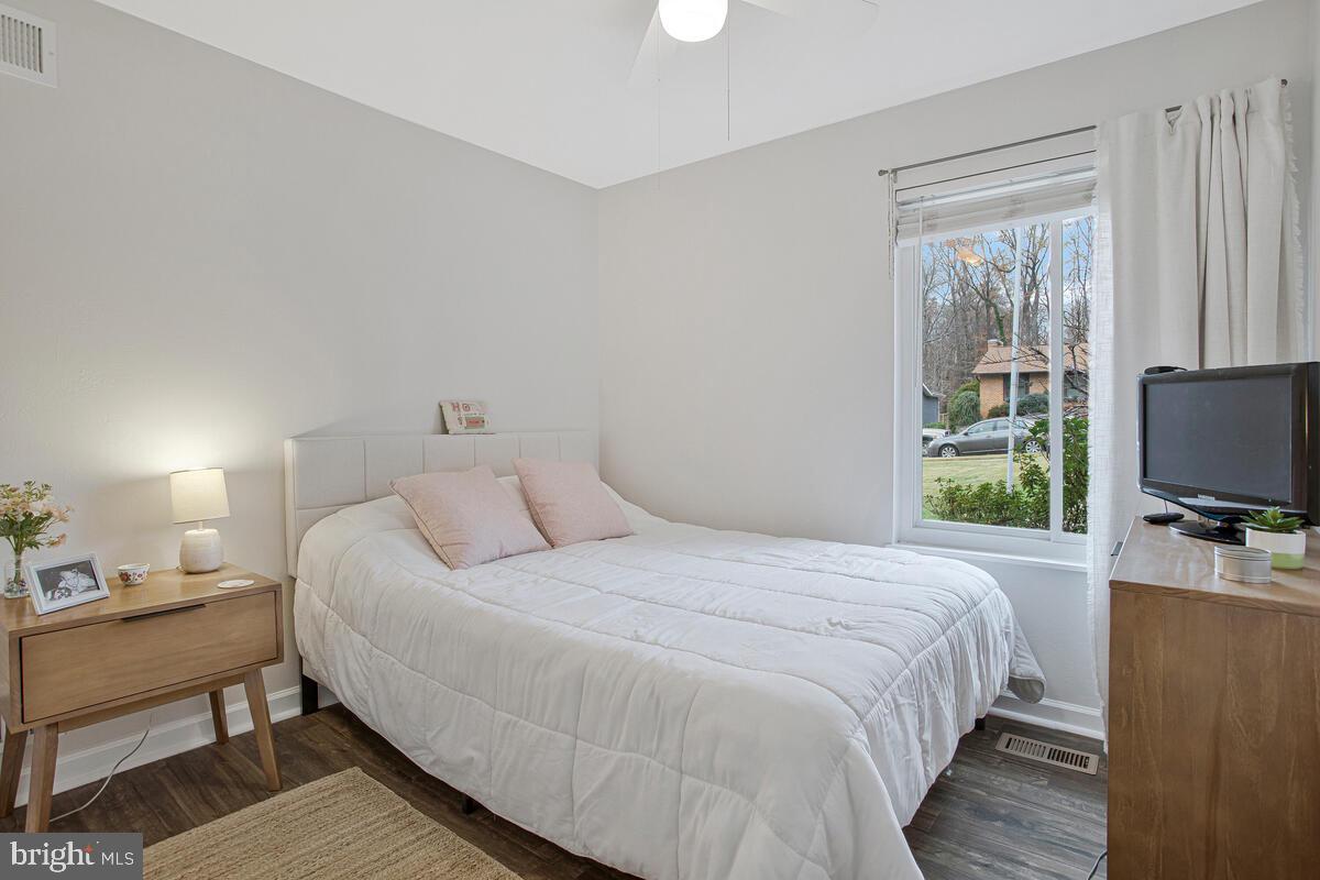437 Kingwood Road Linthicum Heights, MD 21090 - Photo 23 of 38 a bedroom with a bed a large window and a flat tv screen on a dresser