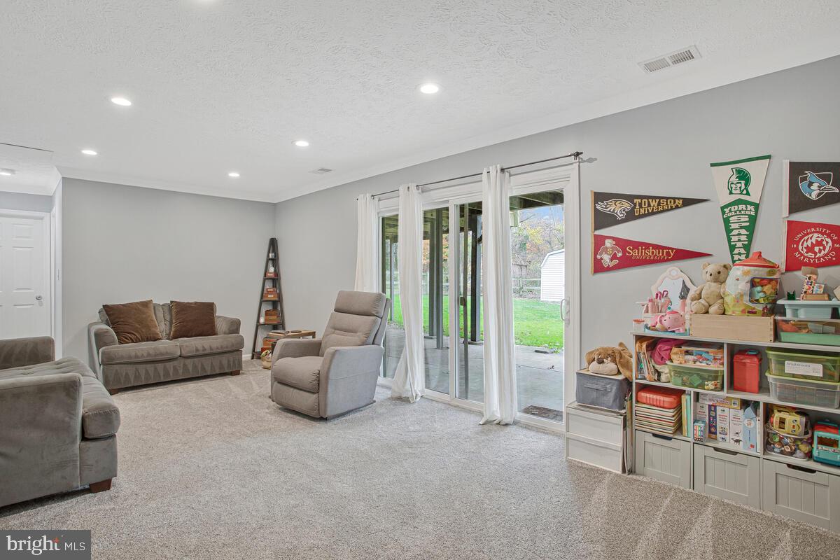 437 Kingwood Road Linthicum Heights, MD 21090 - Photo 25 of 38 a living room with furniture and a flat screen tv